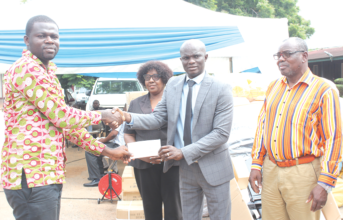 Mr Kingsley Ato Cudjoe (2nd right),  Deputy Minister of Fisheries and Aquaculture, receiving a cheque from Mr Ebenezer Agyiri Domptey (left), a representative of Star Oil Company Limited. With them are other officials of the ministry